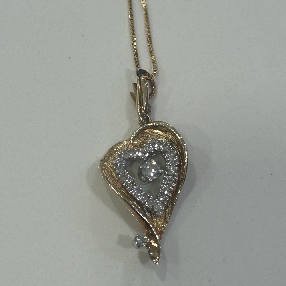 14 karat yellow gold necklace with diamond fancy open heart pendant